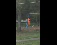 Guy Wearing Orange Costume Trips While Filming Video
