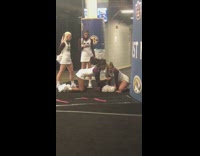 Cheerleaders fierce pose white outfit and pom poms