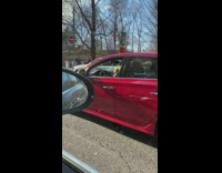Guy sitting in parked car shaking shakers while listening to music 
