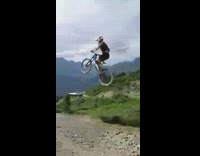 Guy rides blue bicycle up ramp fail 