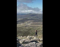 Woman go topless on mountain arms up