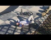 Biker rides off a ramp, spins handle bars and falls down