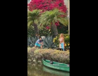 Shirtless girl dance colorful pants green boat