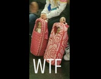 two little girls with dolls in pink back packs