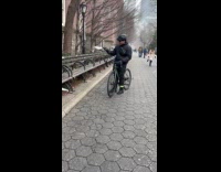 Squirrel jumps on bikers hand at park
