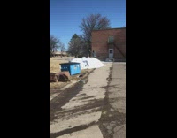 Guy belly flop on pile of snow