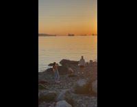 Guy neck crack hold sunflower beach sunset