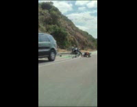 Cyclist crashes on police motorcycle at roadside