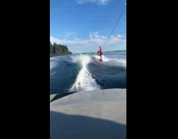 Wakeboarder jump over guy hold Canadian flag