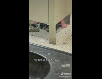 Guy has shoes off in public restroom