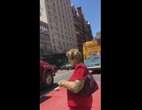 Lady in red ha hair and face covered in gold 