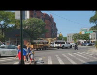 Giant dinosaur rides on truck at the street 