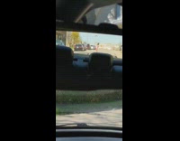 Red shorts girl dances car rearview mirror 