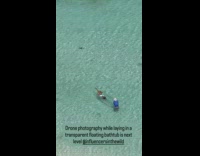 Woman in crystal kayak beach drone video