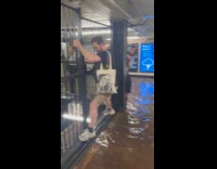 People climb railings to avoid station flood