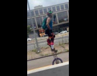 Collab WINY - Man teal backpack ride tall unicycle street part 2