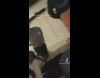 Guy reacts to woman kneeling over him at party 