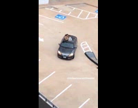 Couple outside black car sunroof drive rooftop