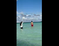 Man Stands and Poses on Shallow Beach