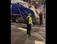 Firefighters Extinguish Fire from Blue Garbage Truck 