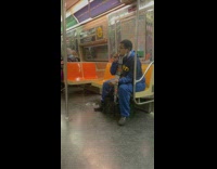 Man in blue outfit smoking on subway
