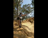 Girl on rope swings jumps off and falls in sand 