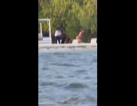 Woman twerks while beach employee films her