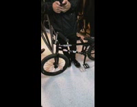 Guy brings black bike into subway train