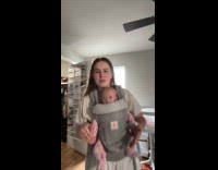Woman asking if she is wearing baby carrier right 