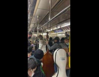 Guy forces christmas spirit onto subway train passengers