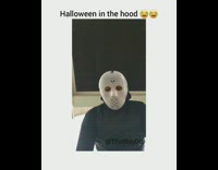 Halloween in the hood, guy in Jason mask costume steals bowl of candy and table from porch