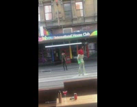 Guy shiny jumpsuit red wig middle street