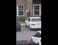 White shirt guy holds black dog girl