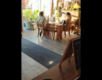 Woman with coffee poses inside the restaurant