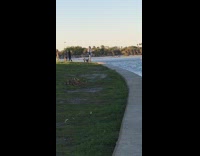 Girl poses for photo by water