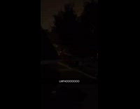 Car speeds through neighborhood street at night
