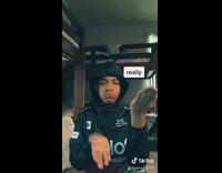 Black polaroid sweater guy puts hood on