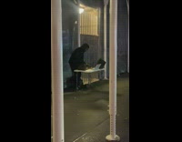 Random DJ on the street djing on a foldable table at night 
