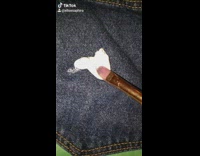 Girl paints in back pocket shorts