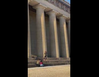 Woman hair flip beside pillar red cloth