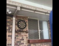 Six darts bullseye dartboard brick wall guy