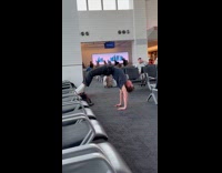 Guy does back bend pushups at airport