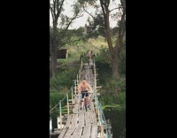 Guy falls on his face while riding bike on bridge 