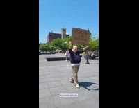 Old guy holds up sign saying to make lox cheaper 