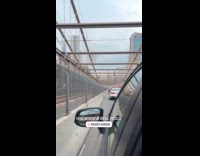 Guy climbs across top of the bridge 