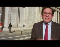 Woman in red top poses behind the news reporter on TV Part 6