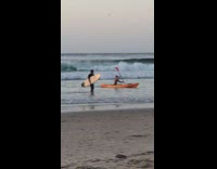 Man gets off kayak boat for video shoot at the beach