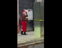 Buff shirtless santa poses for a photoshoot