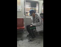 guy in grey jacket and blue hat sleeps on subway wakes up 