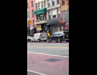 Man rides scooter while holding metal rod